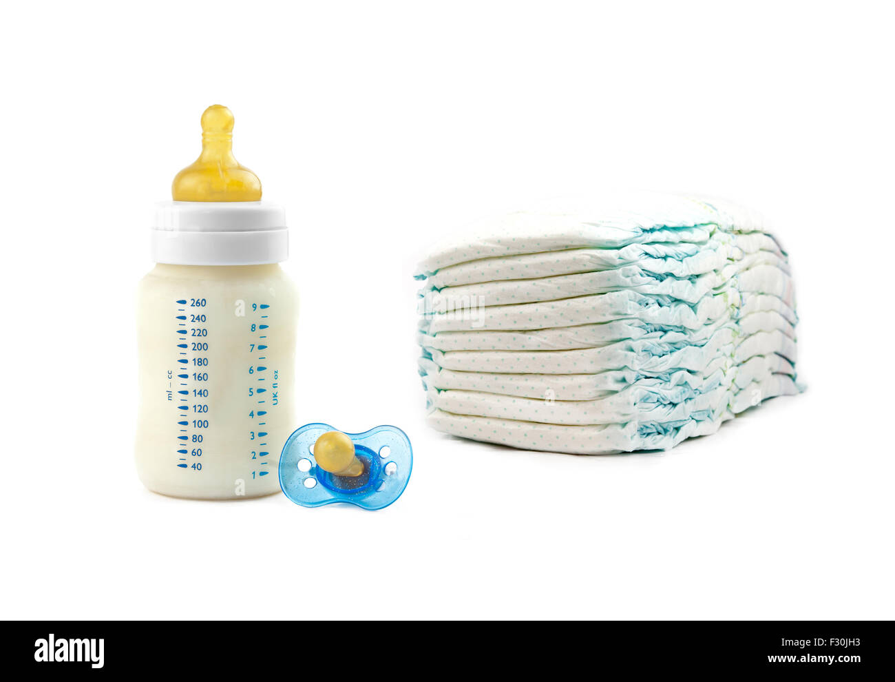 diapers, milk bottle and pacifier isolated on white background Stock ...