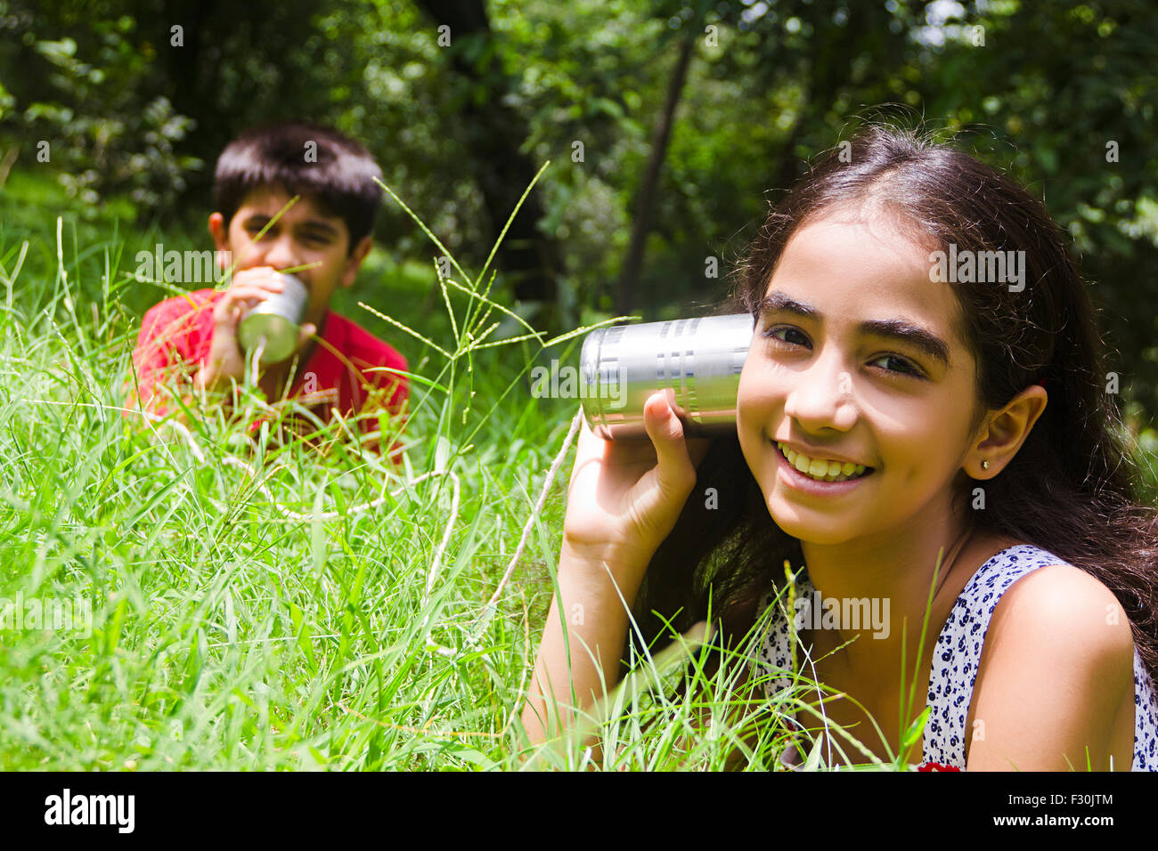 Kid Child Communicate; Communicating; Courtyards; Daytime; Excited; Exhilarating; Focus On Foregrounds; Head And Shoulders; Indulgent; Satisfied; Sibling; Siblings; Togetherness; Toy Phones; Travel Destination; Travel Destinations; Unworried; Vacations Ca Stock Photo