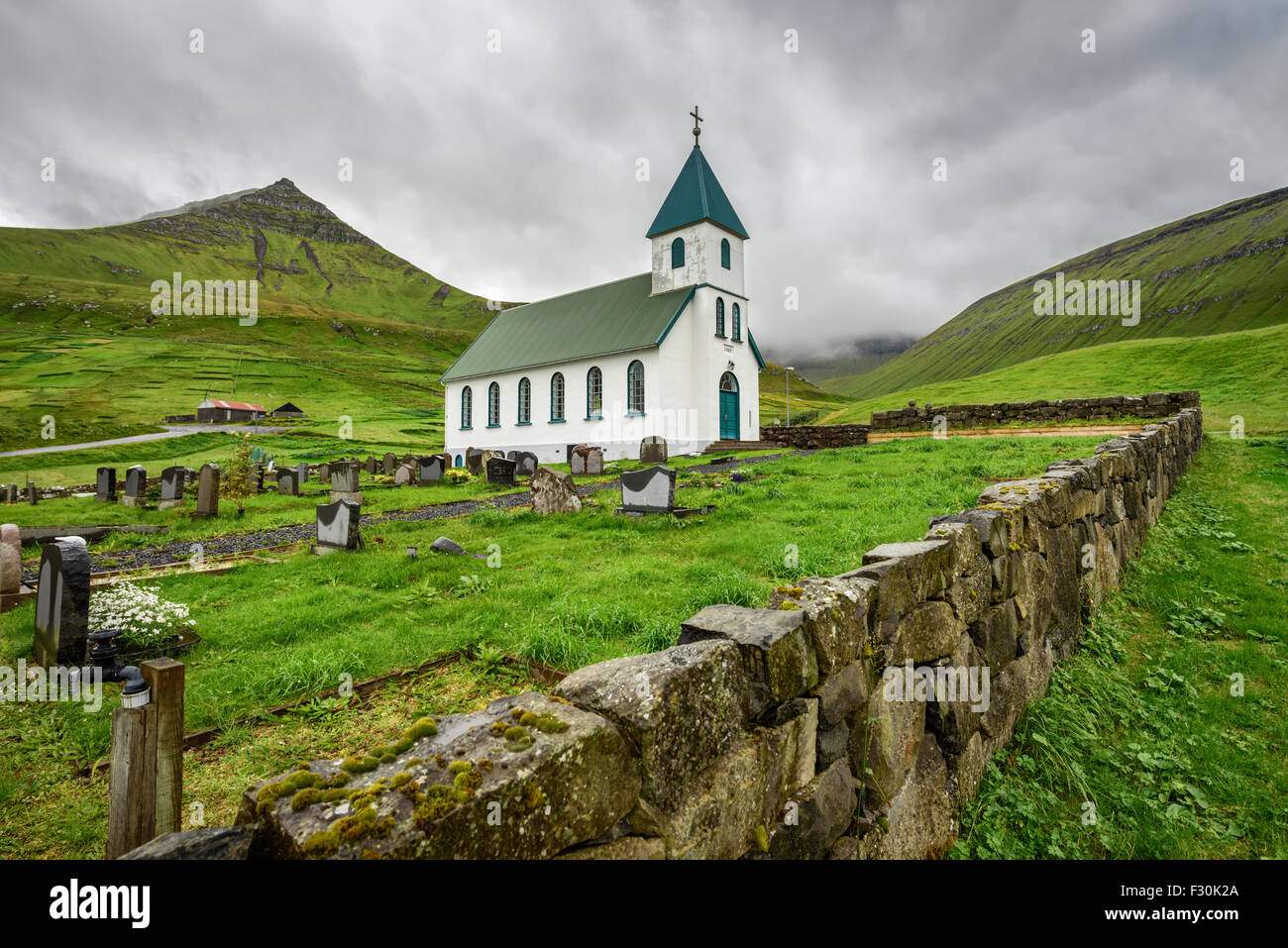 Small village church with cemetery in Gjogv located on the northeast tip of the island of Eysturoy, Faroe Islands, Denmark Stock Photo