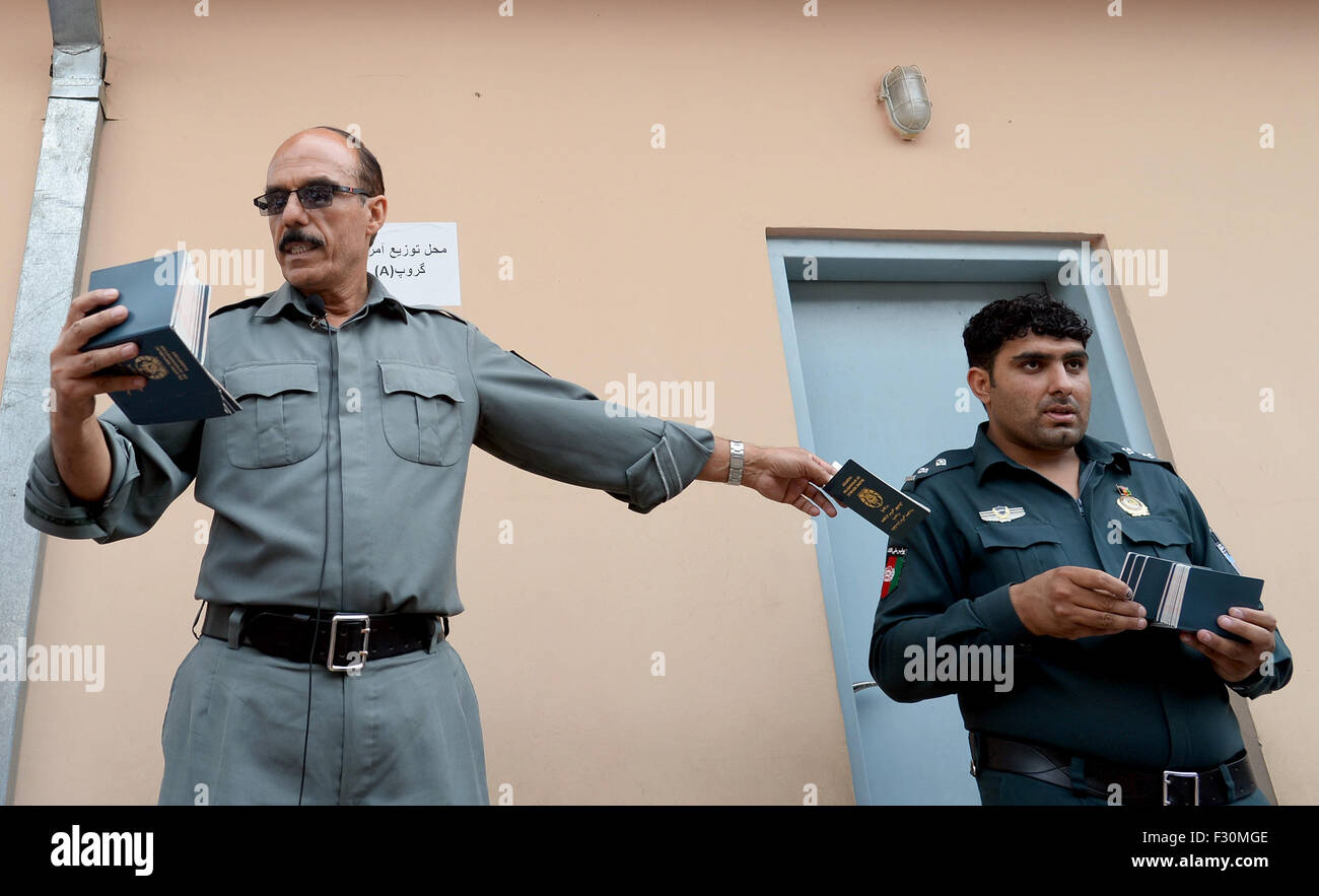 Kabul, Afghanistan. 22nd Sep, 2015. An Afghan police officer distributes approved passports at a passport office in Kabul, Afghanistan, 22 September 2015. After the Taliban regime was overthrown, many refugees returned to Afghanistan. The number of people from Afghanistan seeking refuge in the European Union (EU) is only second to Syria as a new mass exodus is setting in. Photo: Subel Bandari/dpa/Alamy Live News Stock Photo