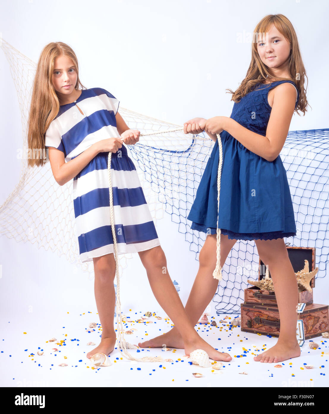 Group 4 happy smiling young teen girls. Fashion lady teenager.Stylish  elegant four children posing studio in blue dresses, catalog clothes.  Girlfriends in beautiful womanly dresses for event,holiday Stock Photo -  Alamy