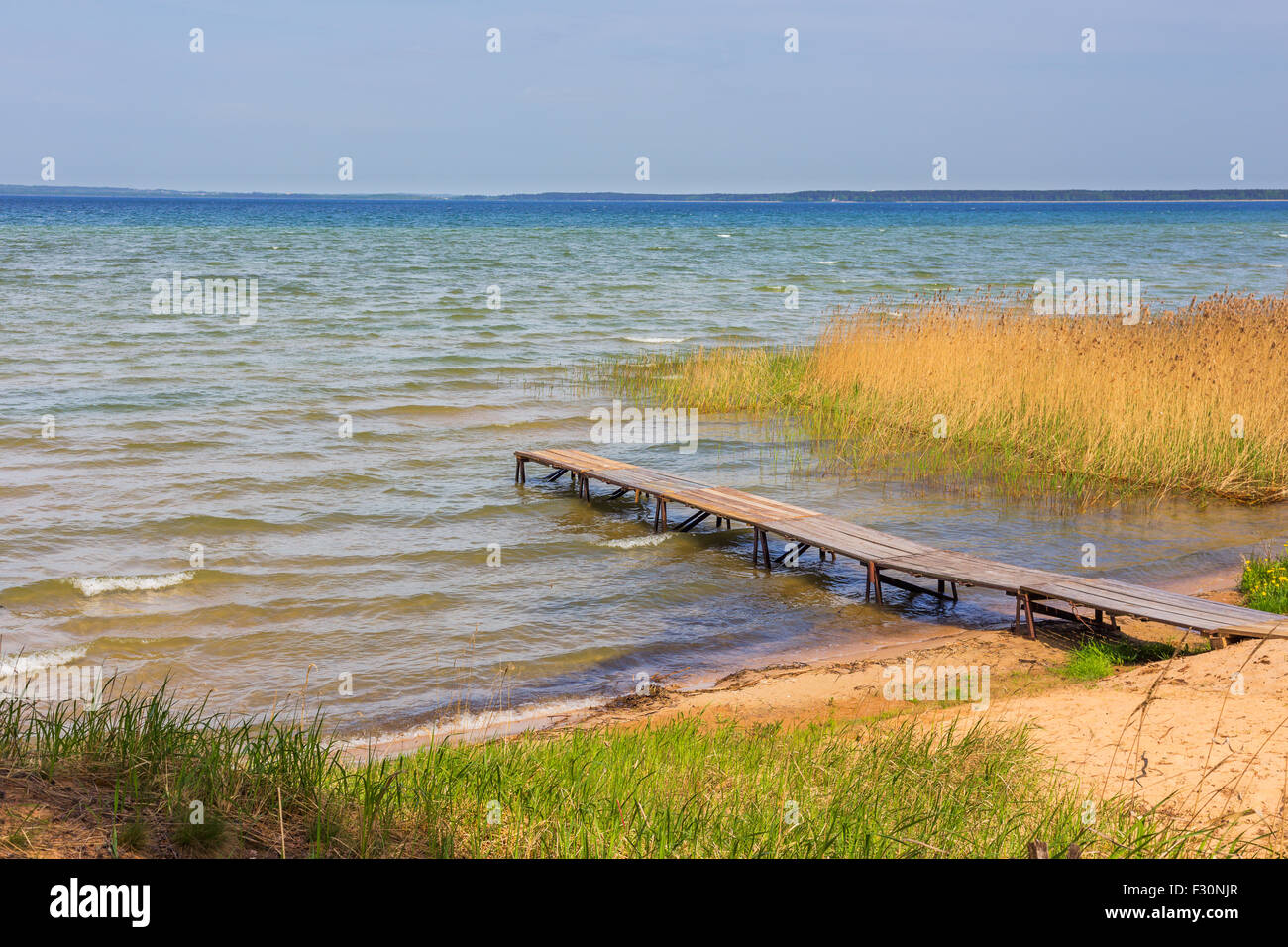 River shore with wooden pier riverbank water Stock Photo - Alamy