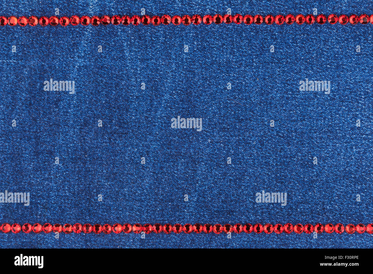 Fashionable background, jeans and red rhinestones Stock Photo - Alamy