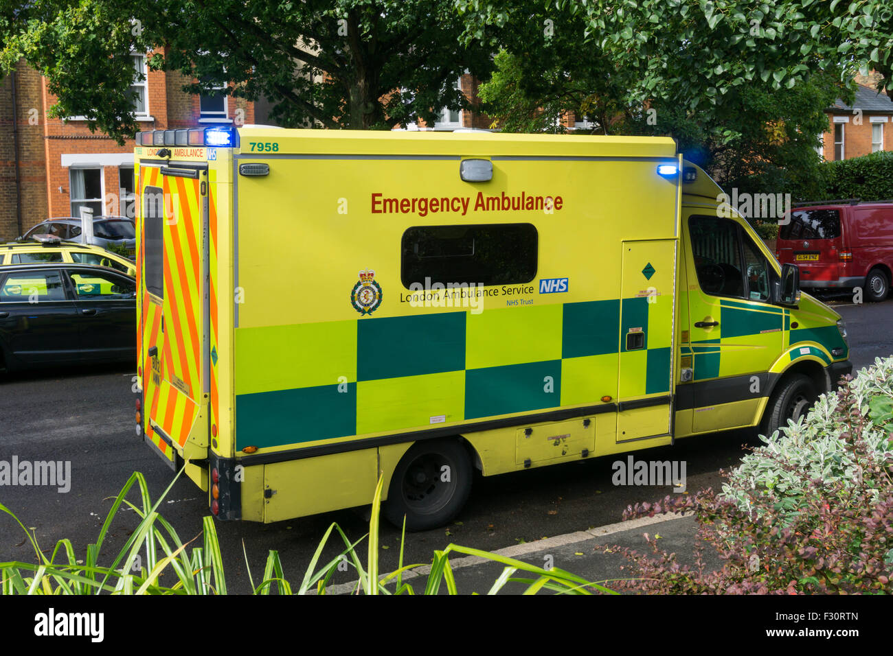 A London Ambulance with blue lights flashing in Bromley, South London. Stock Photo