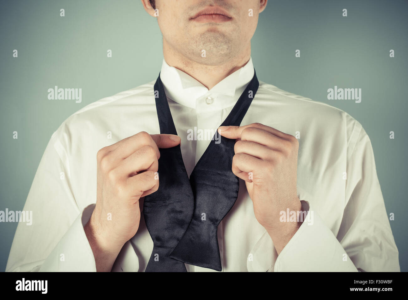 Young man is showing how to tie a formal bow tie Stock Photo - Alamy - Learn To Tie A Tie For A Formal Men'S Event Attire