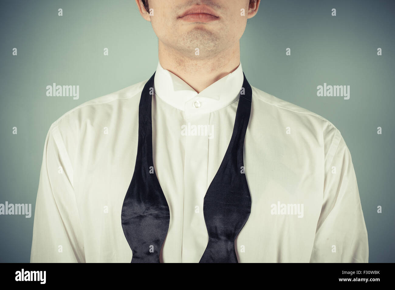 View of Young man is showing how to tie a formal bow tie Stock Photo - Alamy