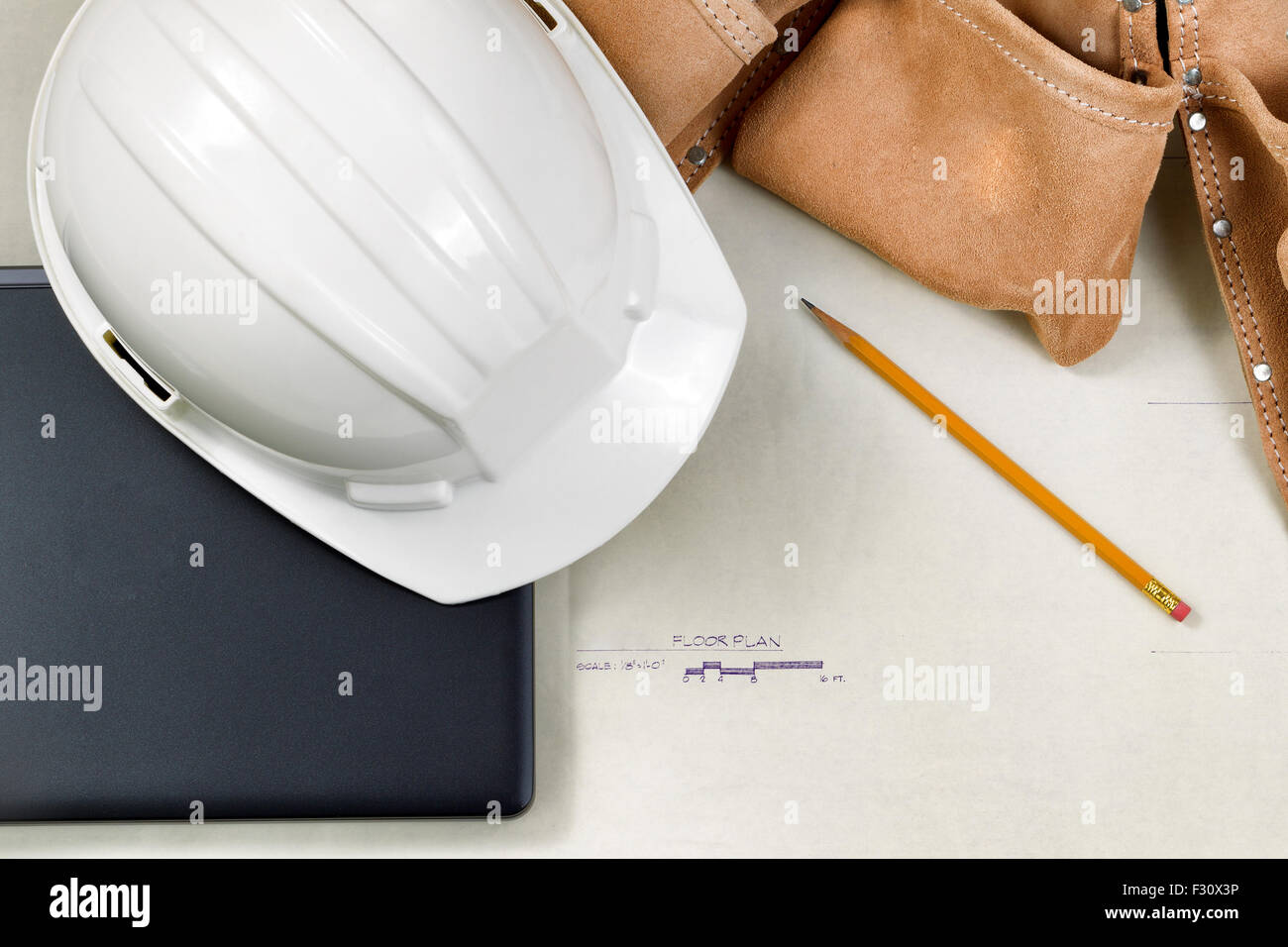 Top view close up of construction contractor tools on top of blue print drawings. Stock Photo