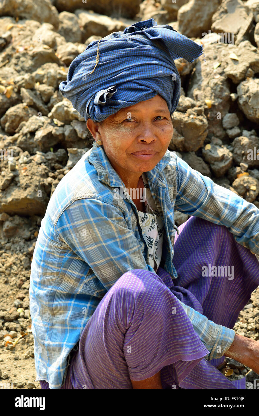 Female pottery worker sitting on the ground in the village of Yandabo alongside the Irrawaddy River, Myanmar (Burma,Birma) Stock Photo