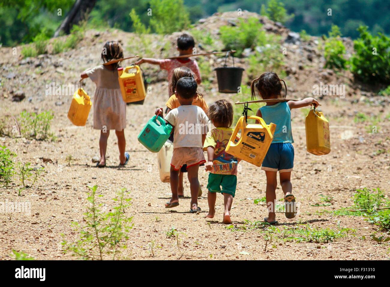 Children carry water buckets in Laos. Lack of running water is a