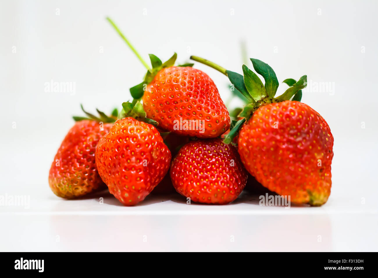 Strawberry berries on a white background Stock Photo - Alamy