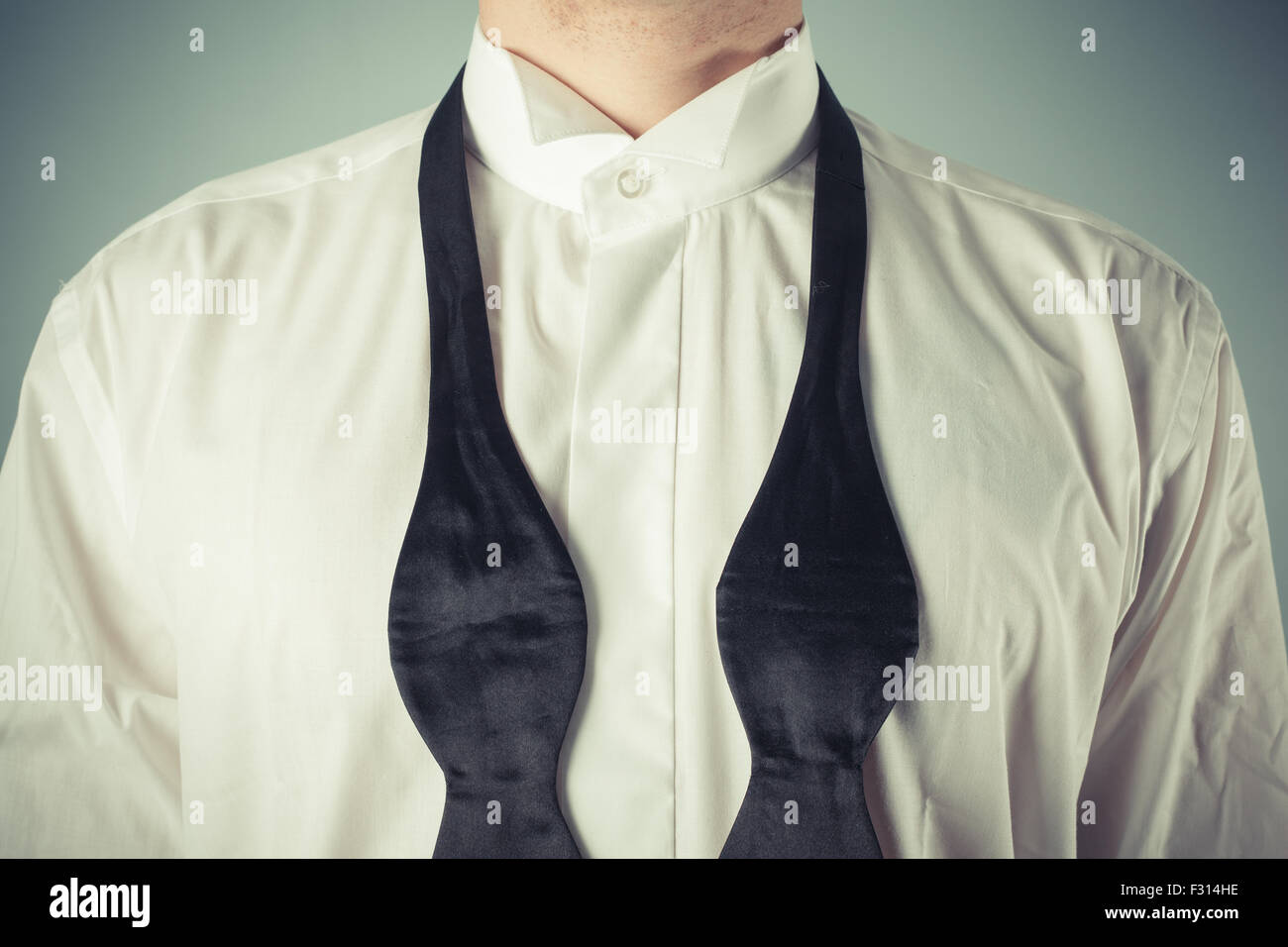 Picture of Young man is showing how to tie a formal bow tie Stock Photo - Alamy