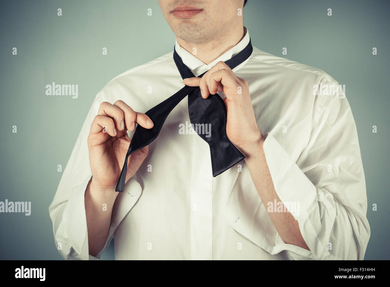 Young man is showing how to tie a formal bow tie Stock Photo - Alamy - Learn To Tie A Tie For A Formal Men'S Event Attire