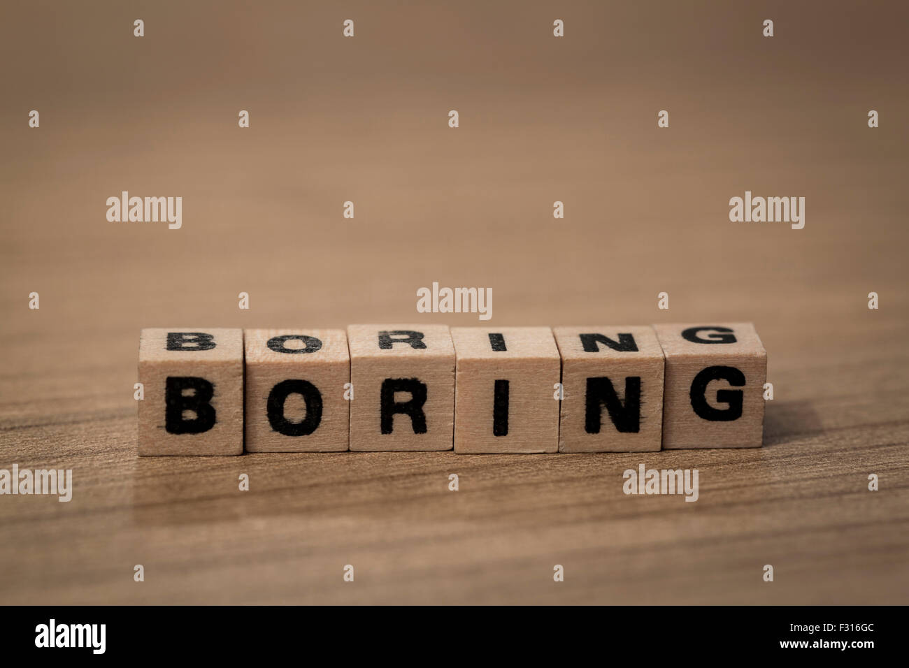 Boring written in wooden cubes on a desk Stock Photo