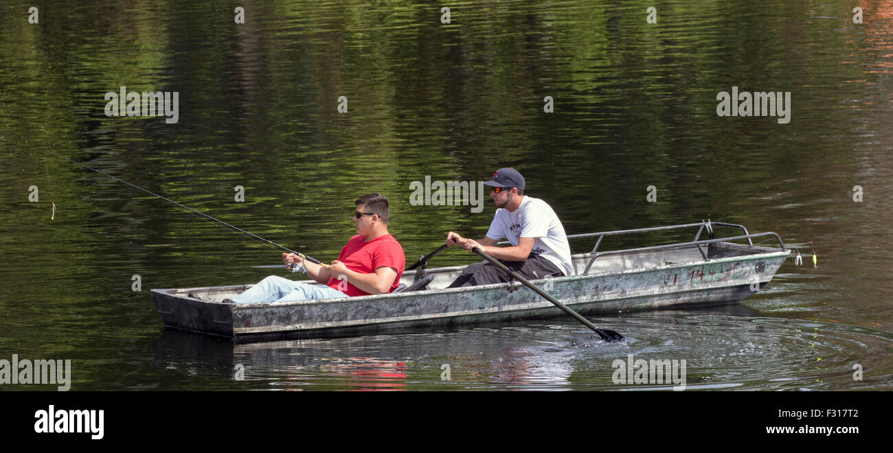 Two young men teenagers fishing from a rowboat Lake Adirondack New York USA US America Adirondack State Park Adirondacks Stock Photo