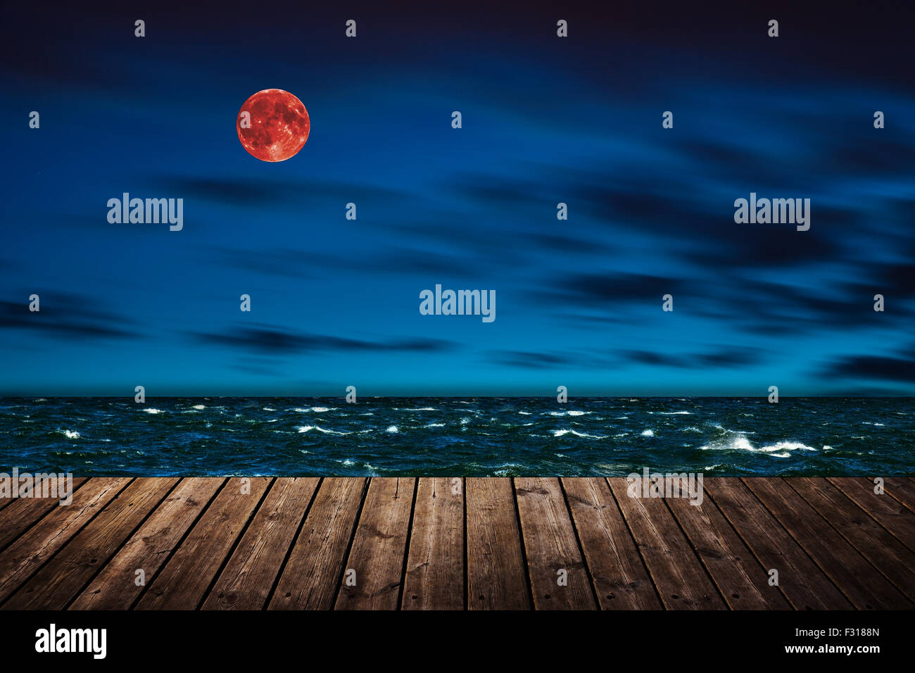 Red full moon in red color also called bloodmoon on the background sea. Stock Photo