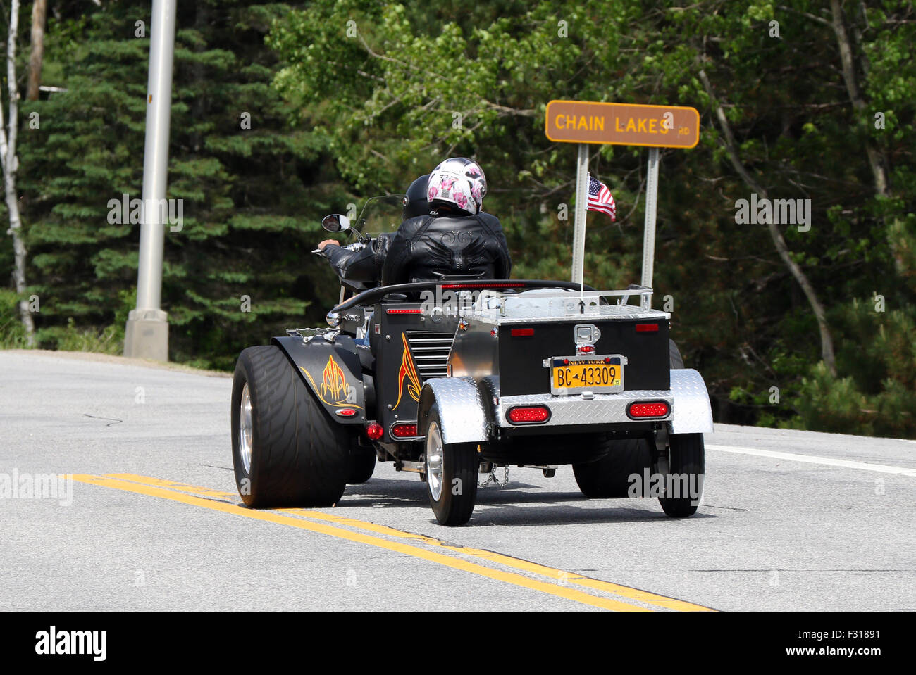 Three wheel wheeler trik motorcycle motorbike towing a trailer. Stock Photo