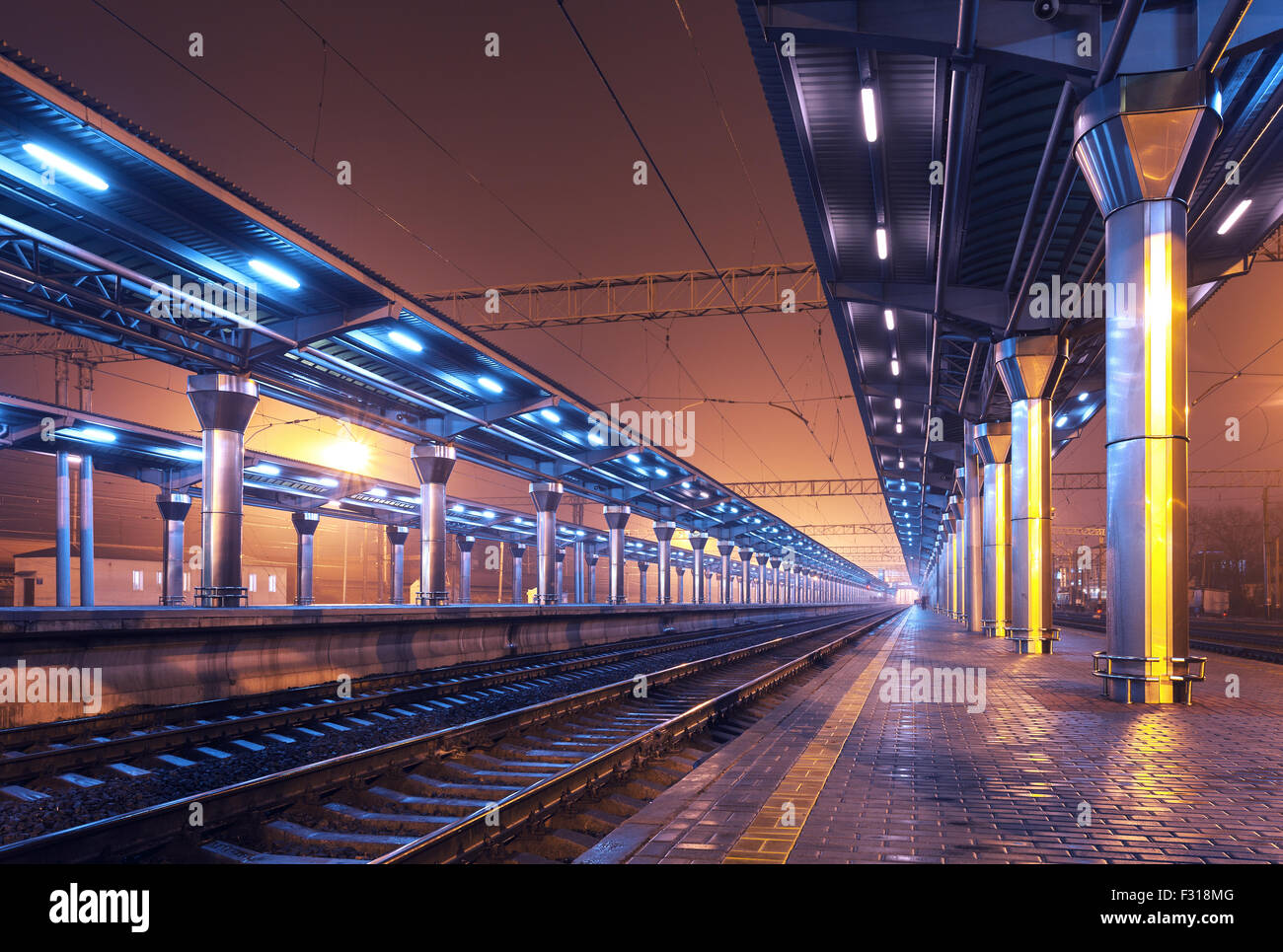 Cargo train platform at night. Railroad in Ukraine. Railway station Stock Photo
