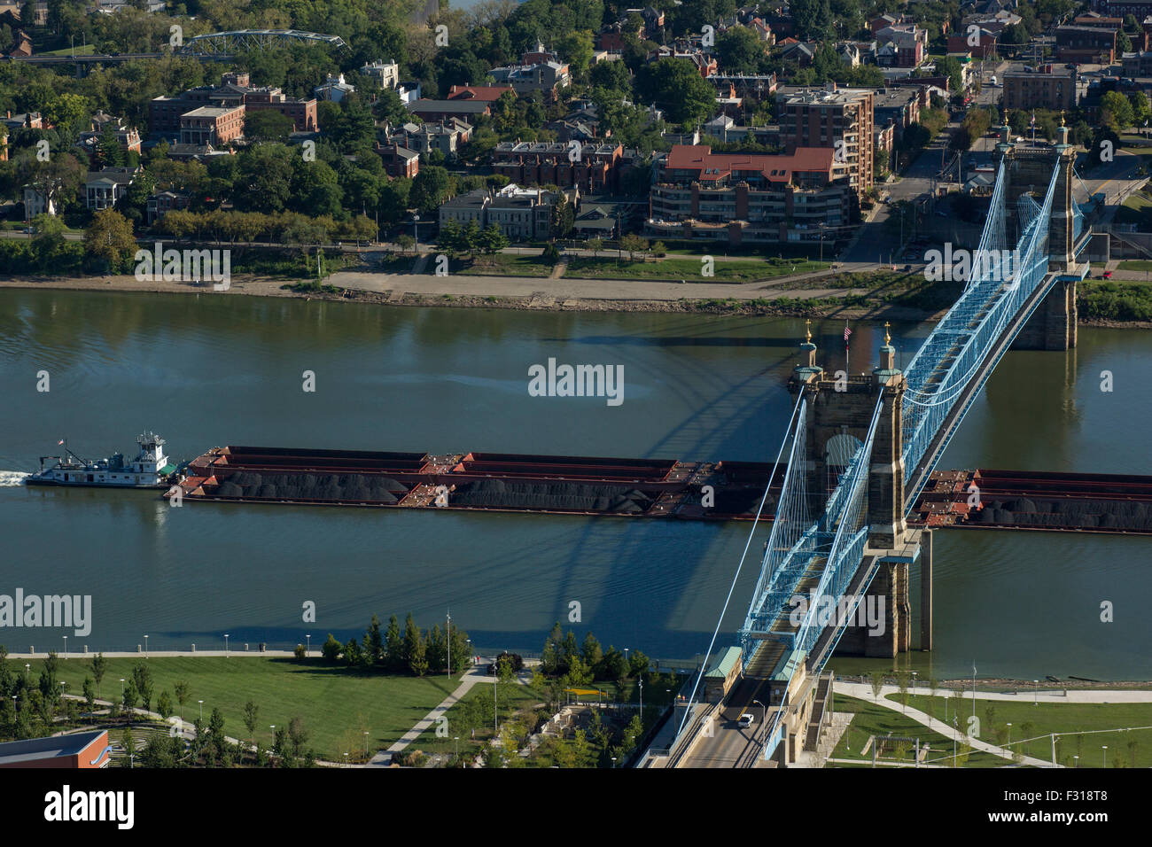 COAL BARGES PASSING UNDER ROEBLING SUSPENSION BRIDGE OHIO RIVER