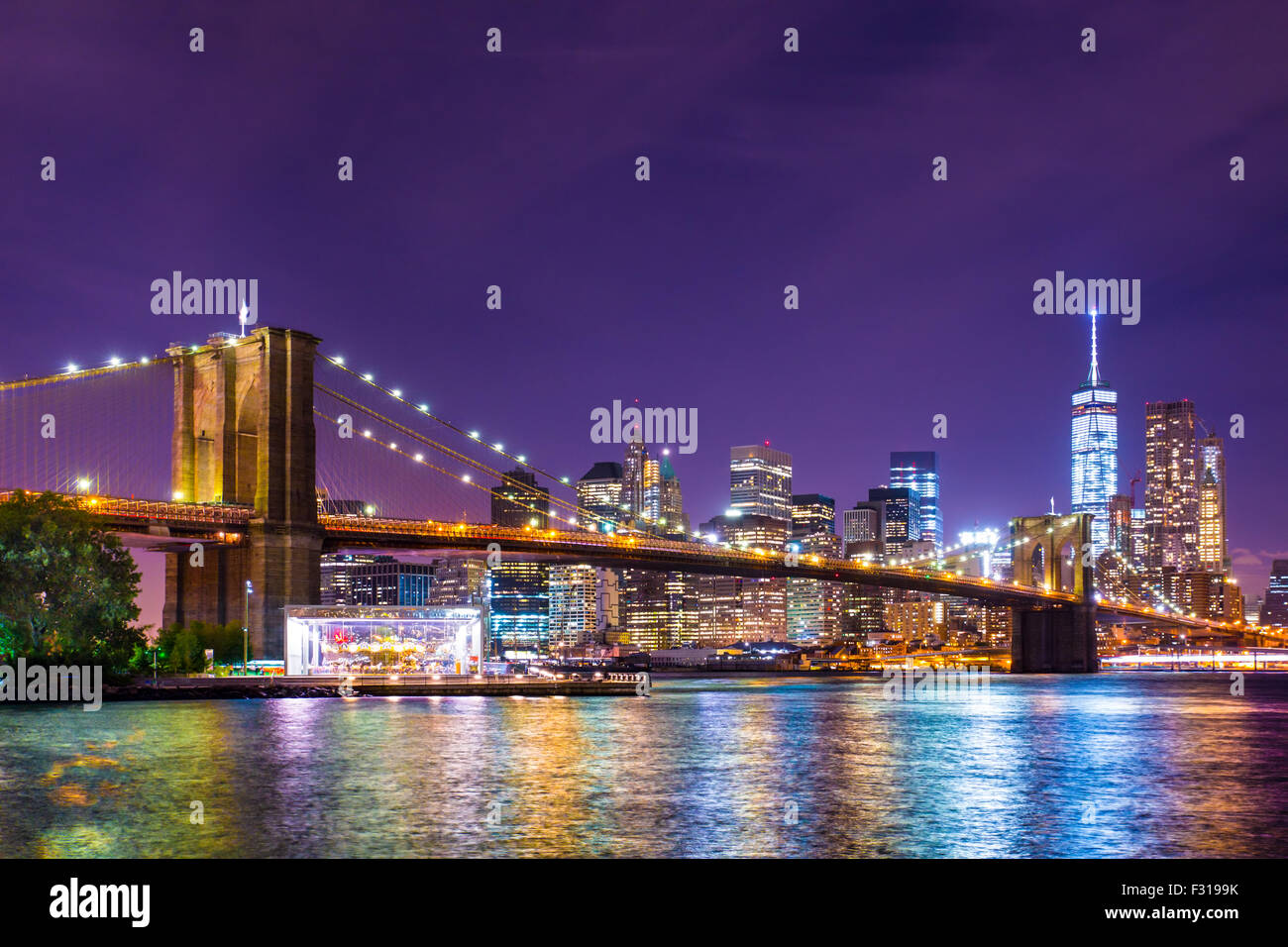 Beautiful Brooklyn Bridge across the East River toward Manhattan New York City lit up. Stock Photo