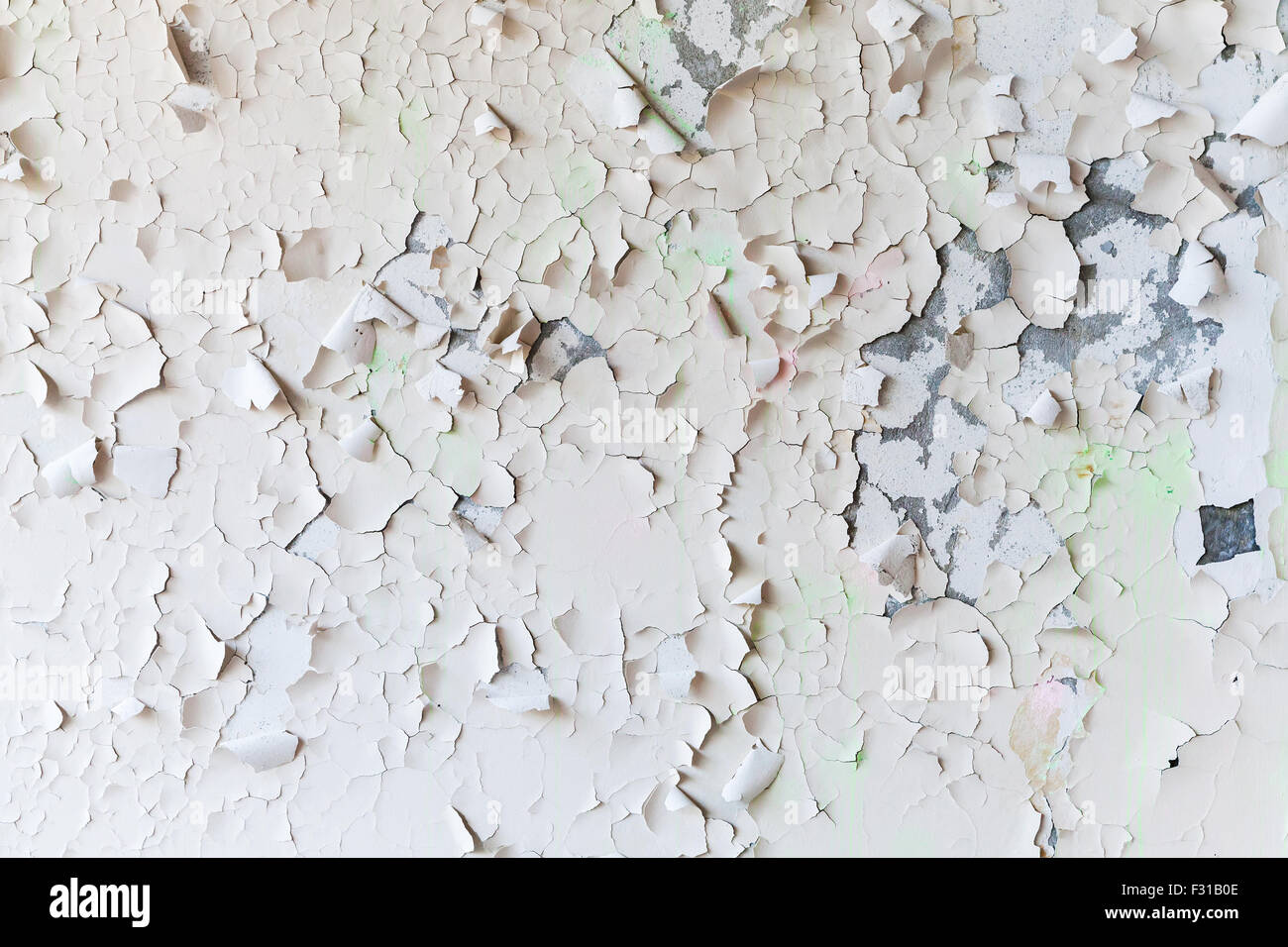 Cracked flaking paint on the wall, background texture Stock Photo
