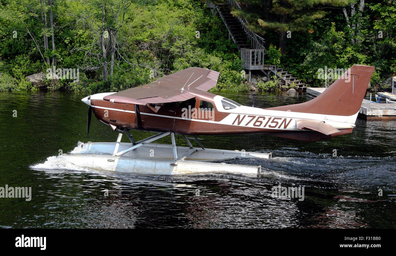 Cessna float plane pontoon seaplane taxing on Long Lake New York USA US America Adirondack State Park Adirondacks Stock Photo