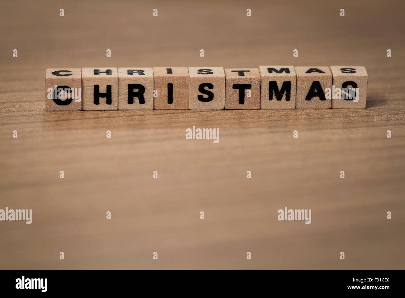 Christmas written in wooden cubes on a desk Stock Photo
