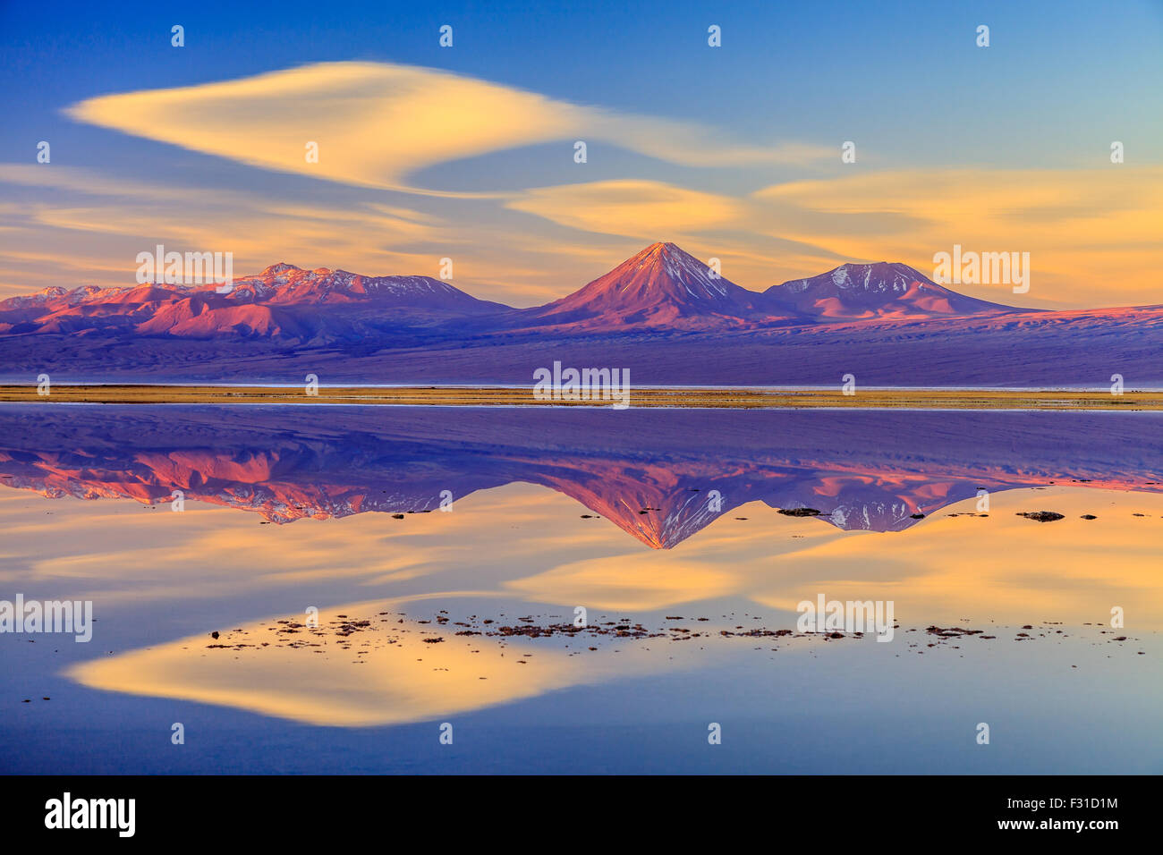 Volcan Licancabur reflected in Laguna Tebinquinche at sunset Stock Photo