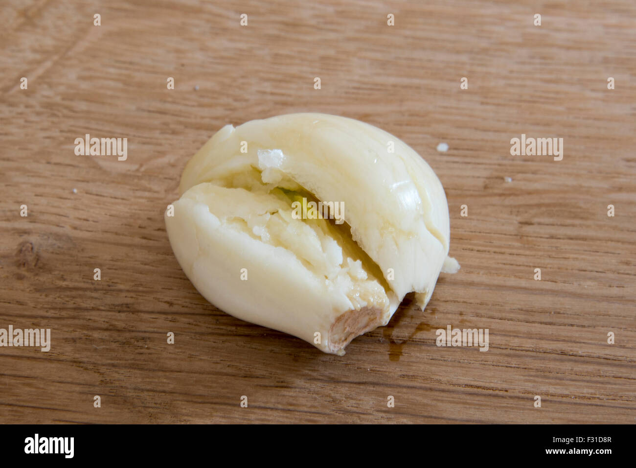 Crushed garlic clove peeled Stock Photo Alamy