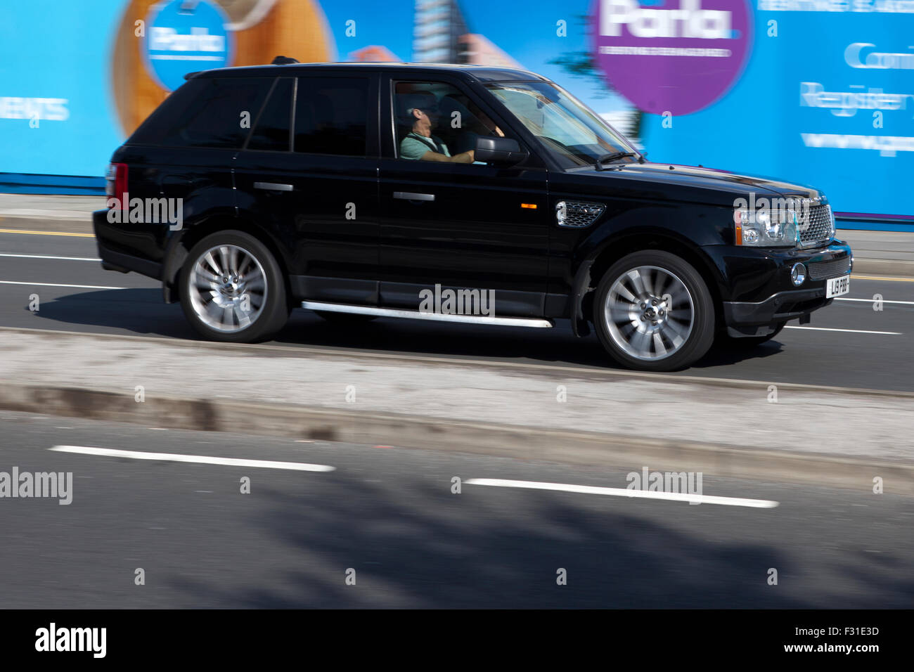 A blurred moving Range Rover Vogue at speed motion blur on 'The Strand ...
