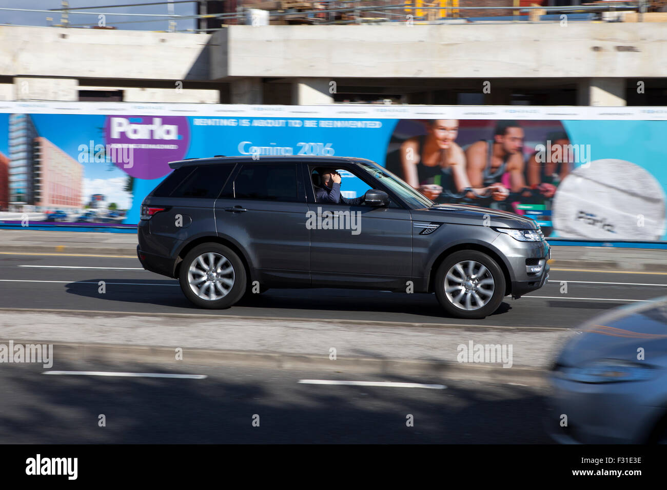 A blurred moving Range Rover at speed motion blur on 'The Strand' at Liverpool One, Liverpool, Merseyside, UK Stock Photo