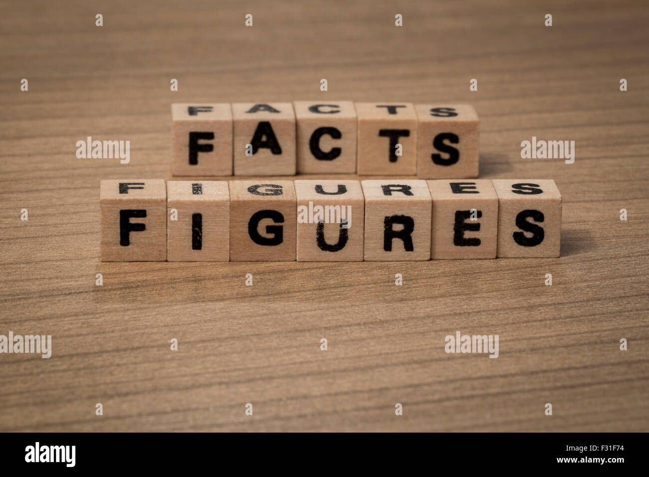 facts and figures written in wooden cubes on a desk Stock Photo