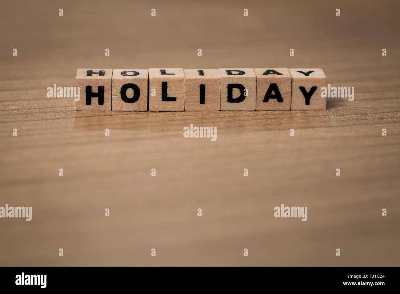 Holiday written in wooden cubes on a desk Stock Photo