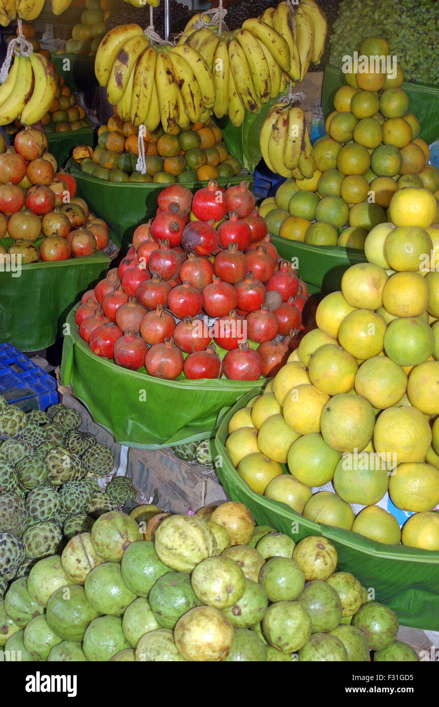 display of pomegranates, Punica granatum, and other tropical fruits by street vendor in Tamil Nadu, South India Stock Photo