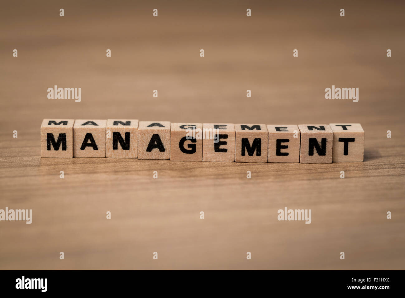 Management written in wooden cubes on a desk Stock Photo