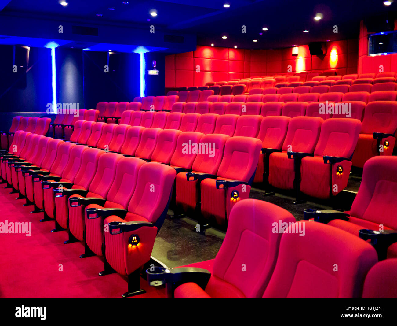 Red seats of cinema hall after the movie Stock Photo Alamy