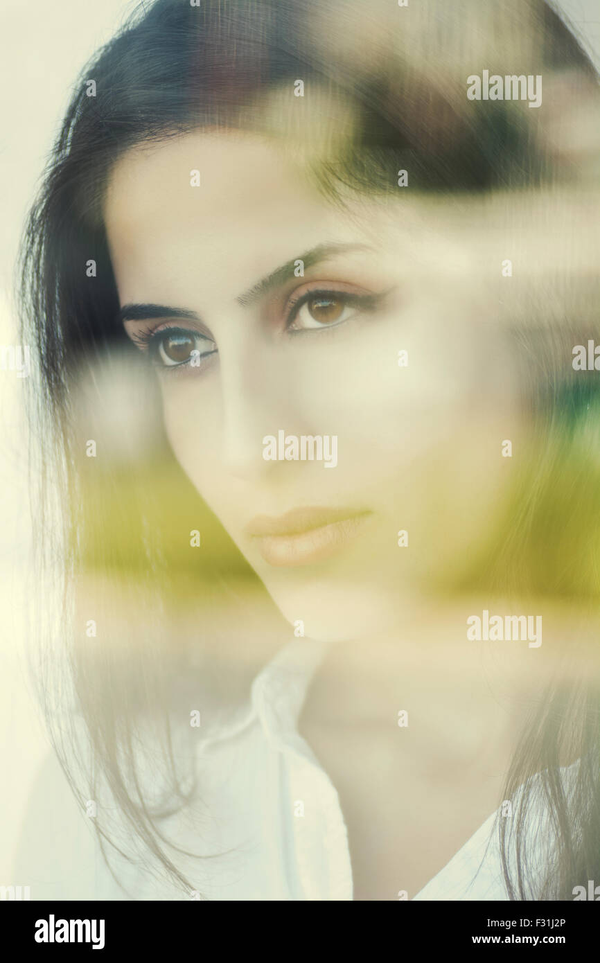 Sad young woman looking out of the window Stock Photo - Alamy