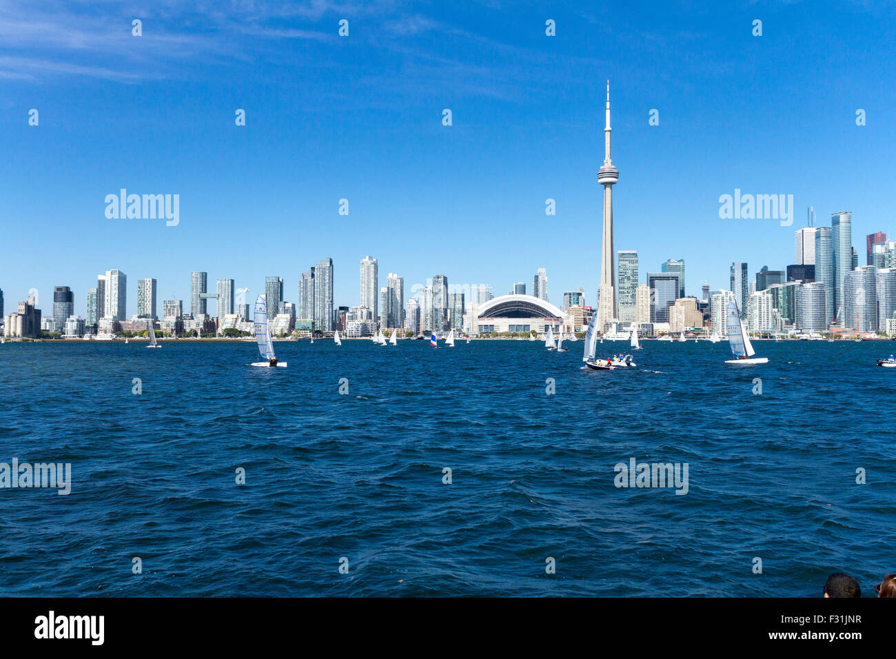 Toronto City Skyline showing Rogers Centre and CN Tower and sailboats along Lake Ontario in Canada Stock Photo