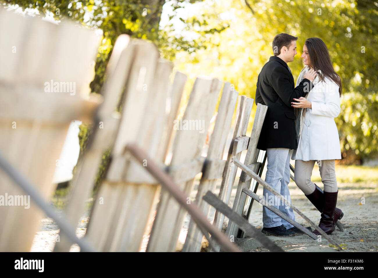 Young couple in the autumn park Stock Photo - Alamy