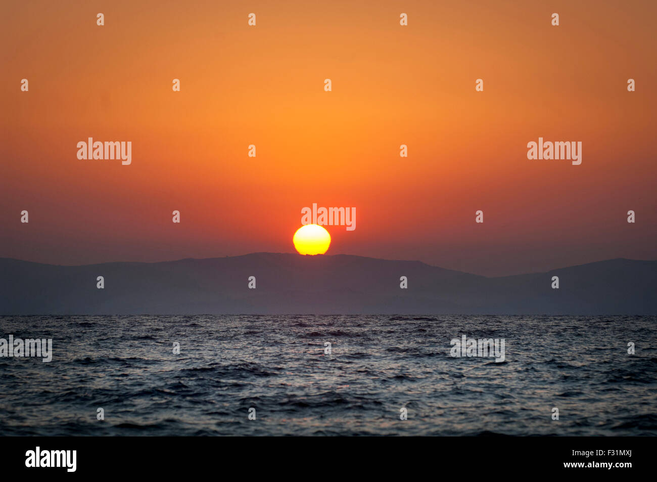 Sun rise over western Turkey. Photographed from the Island of Lesbos, Greece. Stock Photo