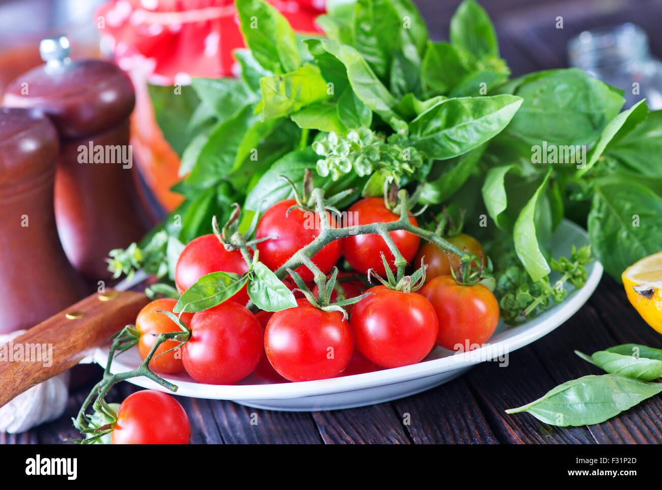 fresh tomato with basil on board and on a table Stock Photo - Alamy