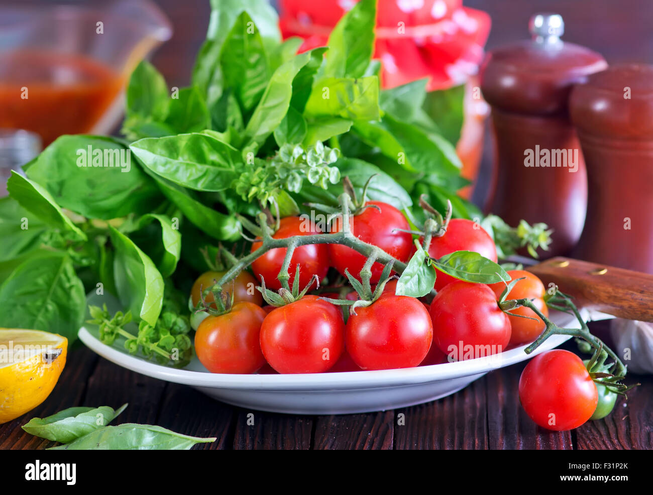 fresh tomato with basil on board and on a table Stock Photo - Alamy