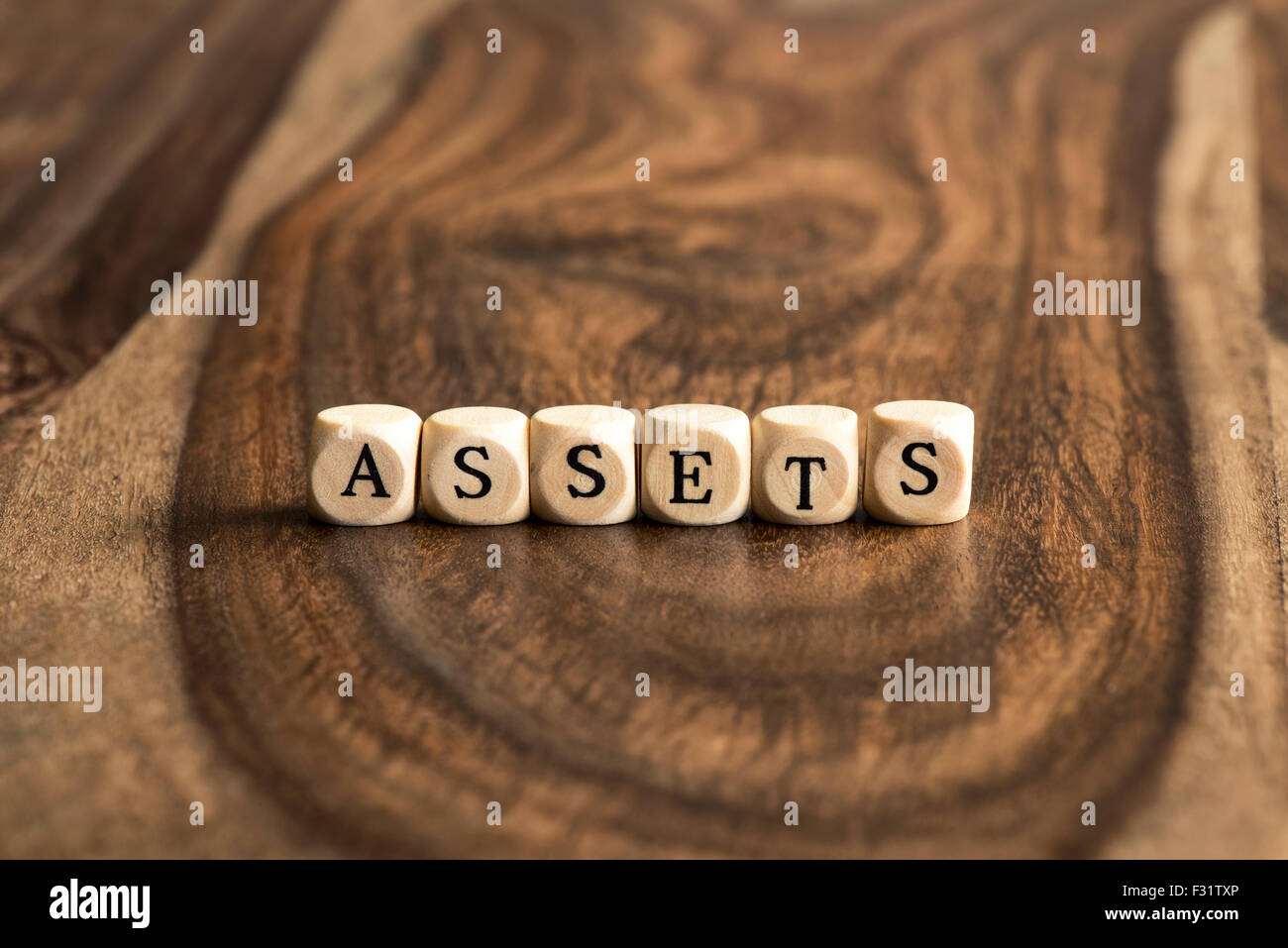 ASSETS word background on wood blocks Stock Photo
