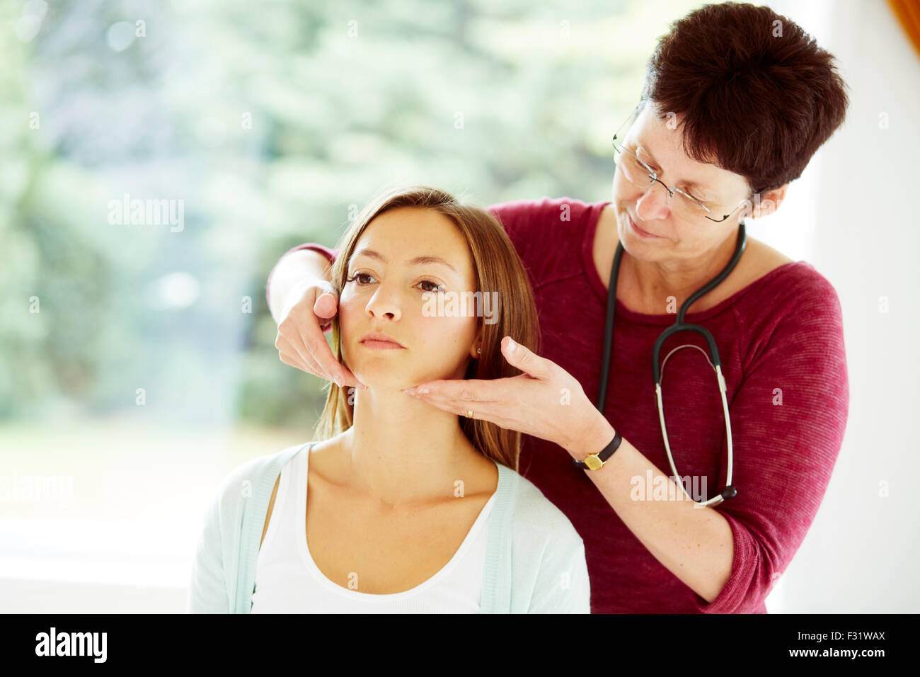Doctor examining patient Stock Photo