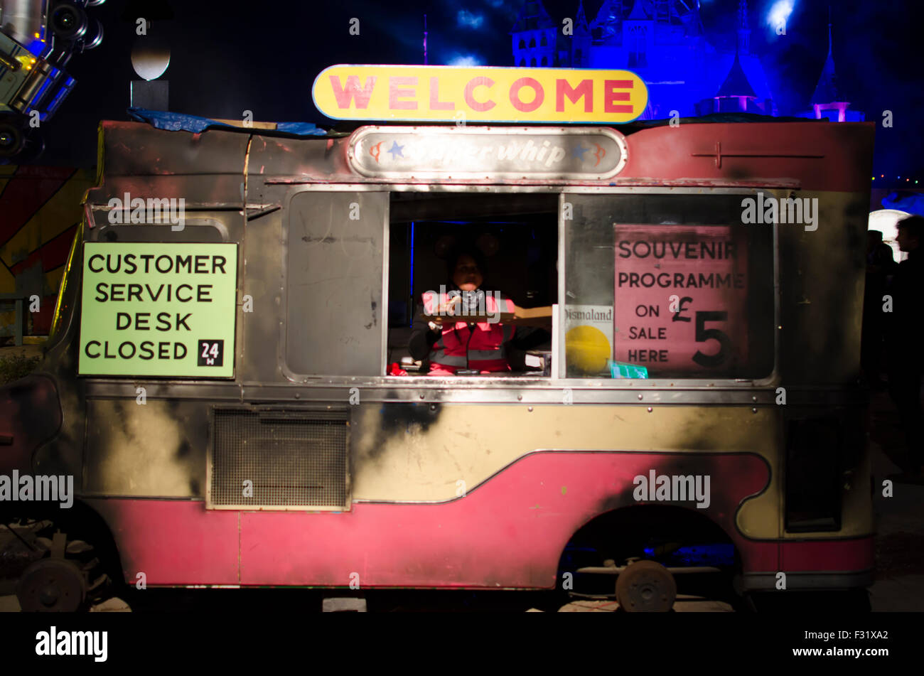 Burnt out ice-cream van at Banksy's Dismaland bemusement park at night during closing party Stock Photo