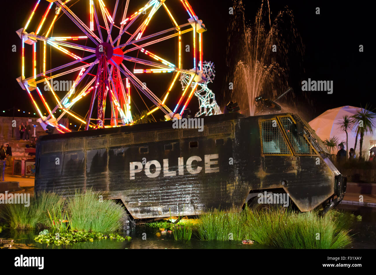 Fountain made out of police riot van at Banksy's Dismaland bemusement park during closing party Stock Photo