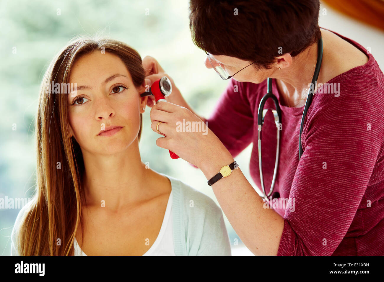 Doctor examining patients ears Stock Photo