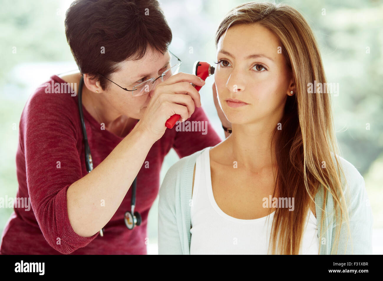 Doctor examining patients ears Stock Photo