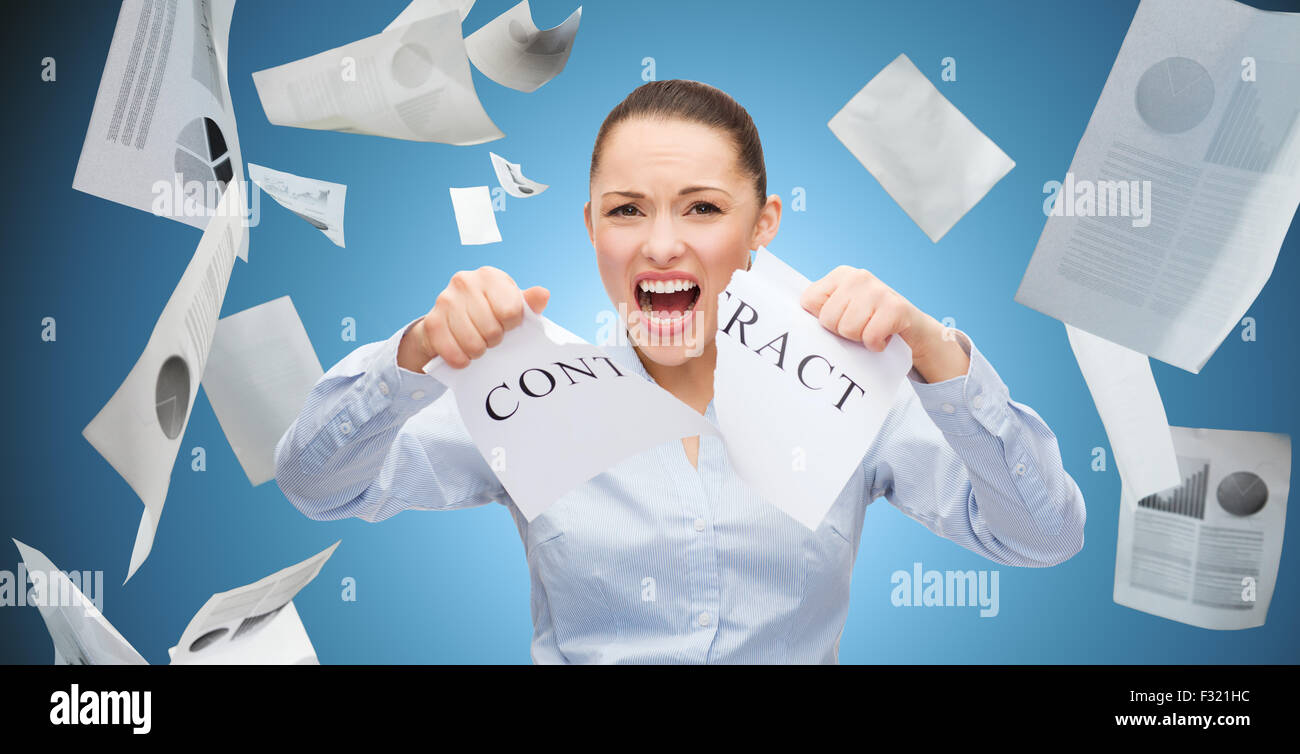 angry businesswoman tearing contract Stock Photo