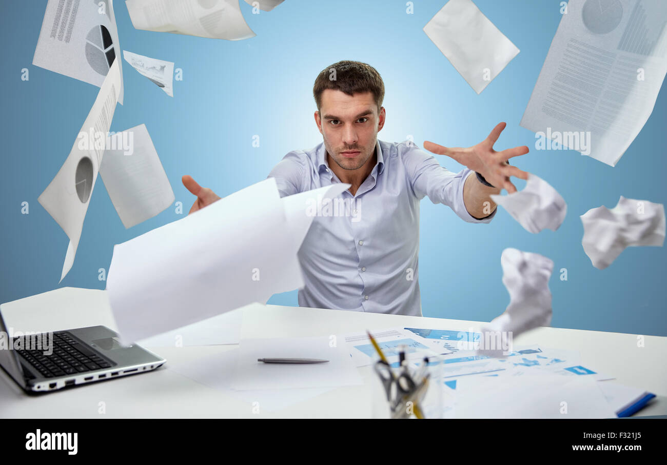 angry businessman throwing papers in office Stock Photo Alamy