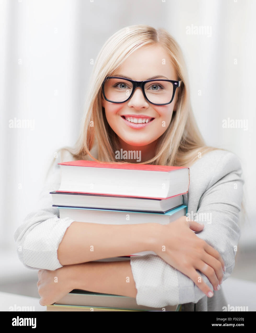 student with stack of books Stock Photo - Alamy